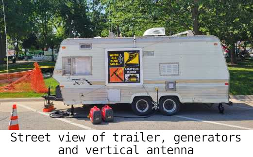 Street view of trailer, generators and vertical antenna
